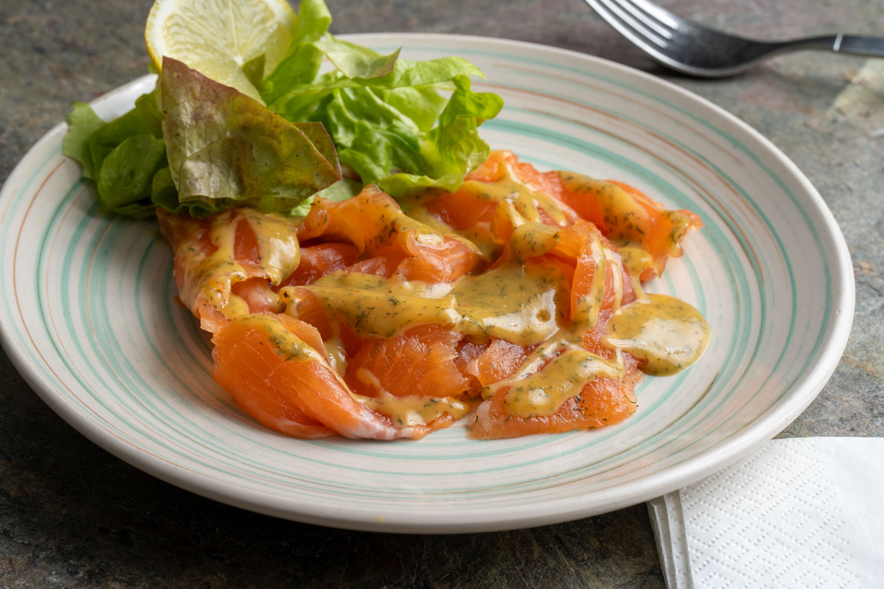 Gravad-Lachsforelle-202501q-PP Lachsforelle liebevoll auf einem hellblauen Teller angerichtet